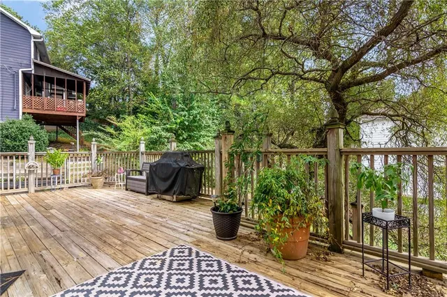 a view of a chairs and table on the wooden deck