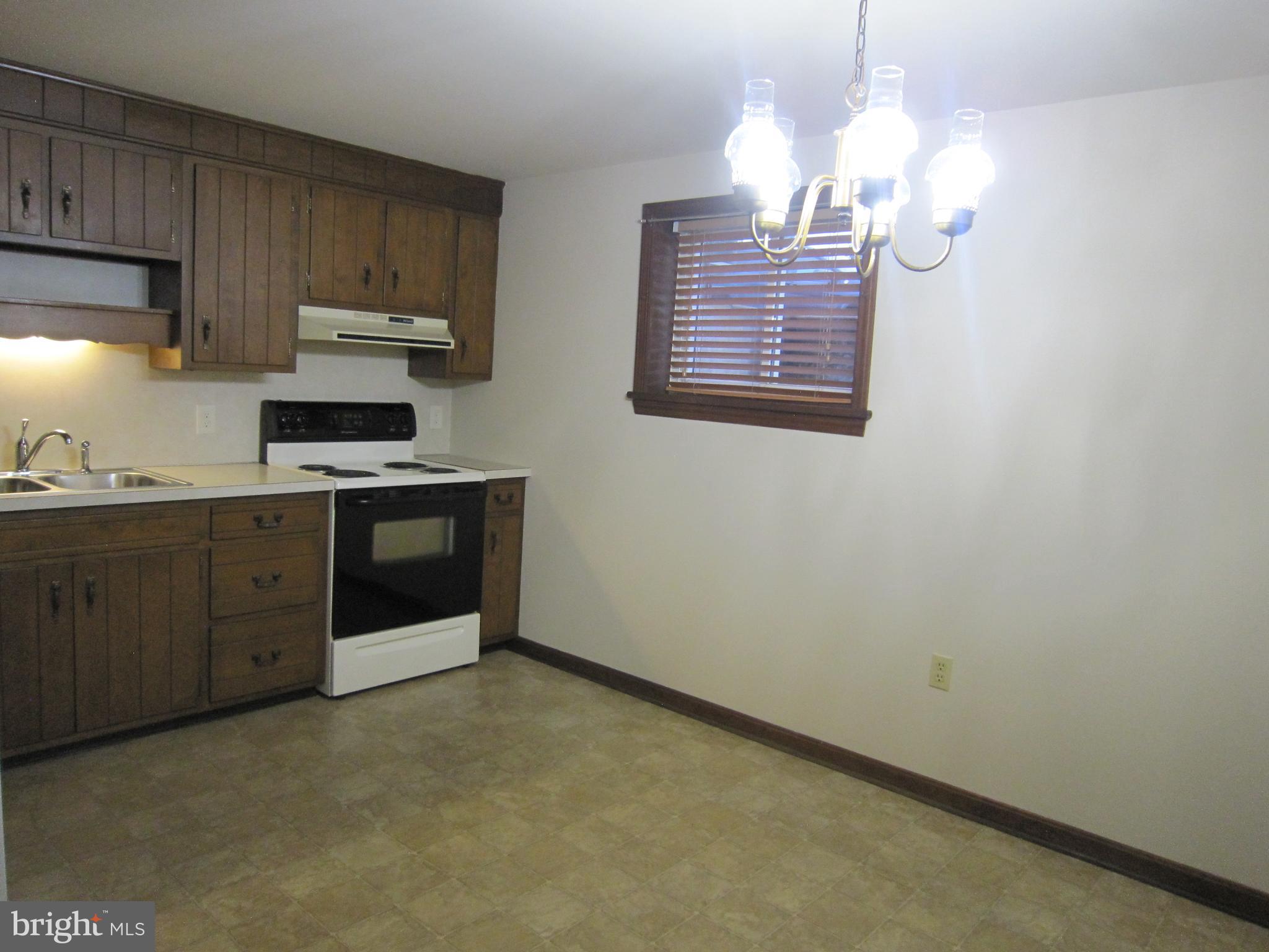304 North Hoover Avenue, Unit B New Holland, PA 17557 - Photo 7 of 17 a kitchen with stainless steel appliances granite countertop a stove a sink and a refrigerator