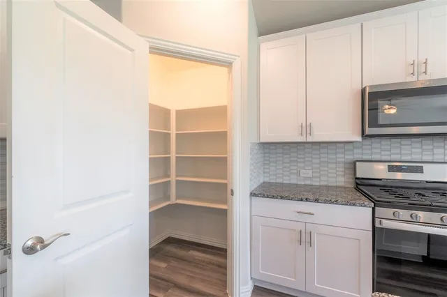 a kitchen with a cabinets and a stove top oven