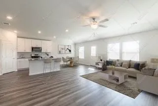 a living room with furniture and kitchen view