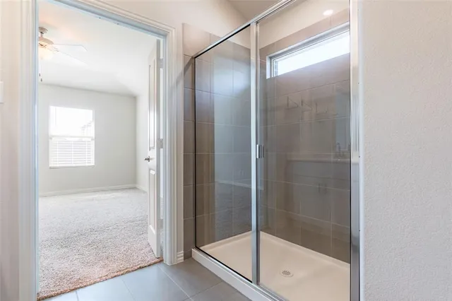 a bathroom with a glass shower door