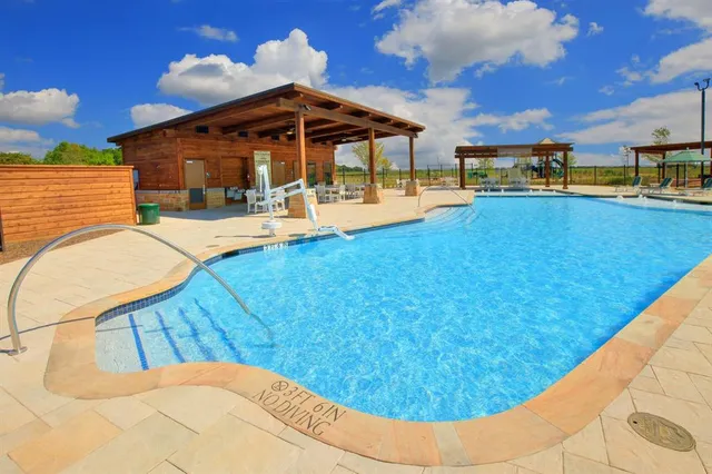 a view of a swimming pool with lounge chairs