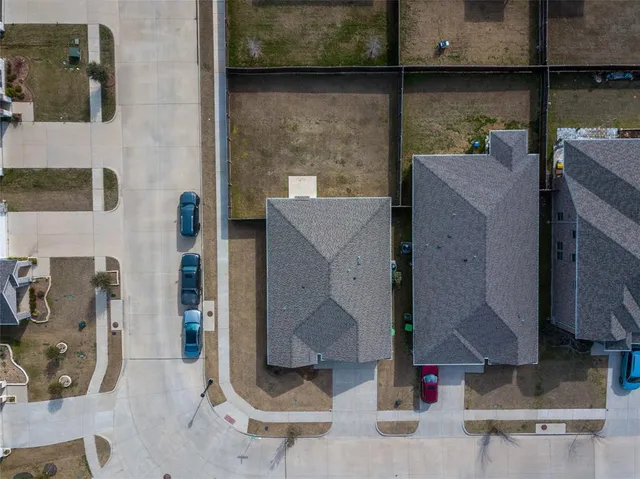 an aerial view of a house with couches and wooden floor