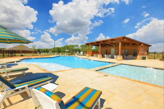 a view of swimming pool with outdoor seating and deck