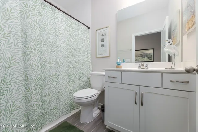 a bathroom with a sink toilet and mirror