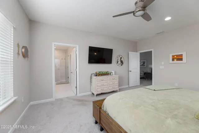 a bedroom with a bed and flat screen tv