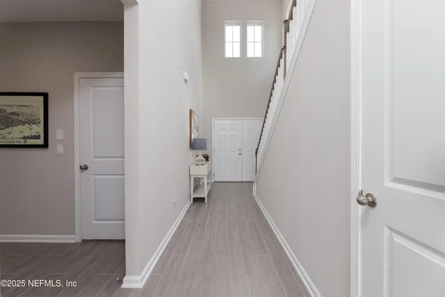 a view of a hallway with wooden floor and entryway