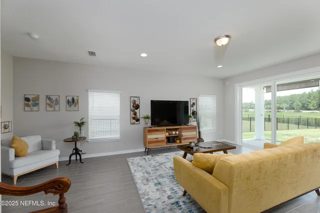 a living room with furniture and a flat screen tv
