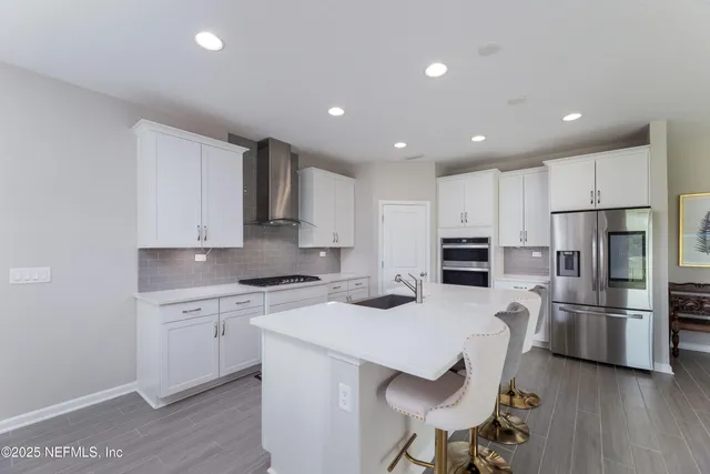 a kitchen with refrigerator cabinets and wooden floor