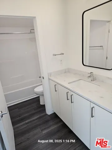 a view of room with window and wooden floor