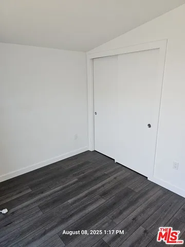 a room with a wooden floor and cabinets
