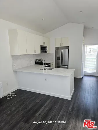 a kitchen with stainless steel appliances a refrigerator stove and microwave