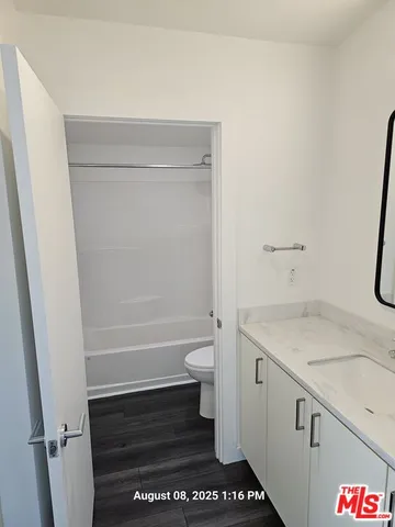 a bathroom with a toilet and a bathtub