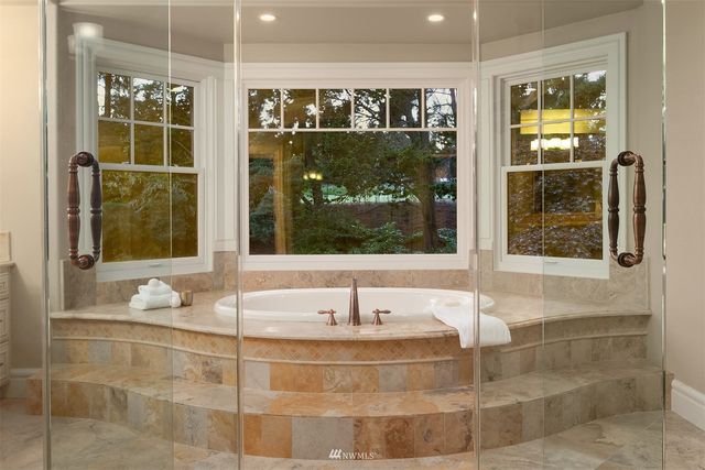 a view of staircase with railing and a chandelier