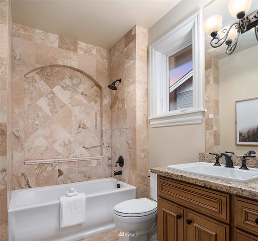 a living room with furniture and a painting on the wall
