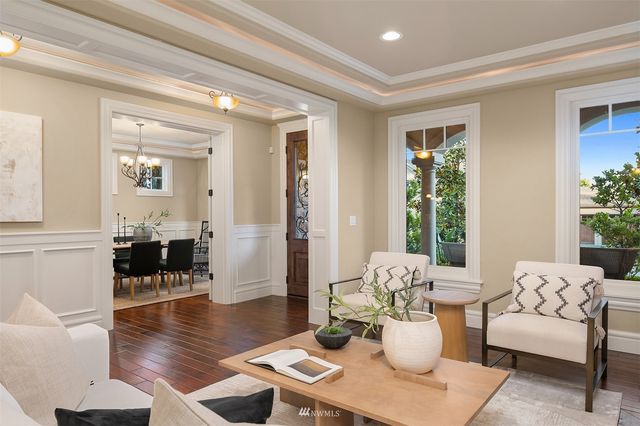 a view of a dining room with furniture a chandelier and wooden floor
