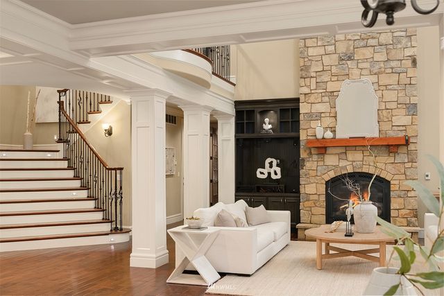 a living room with furniture large window and a fireplace