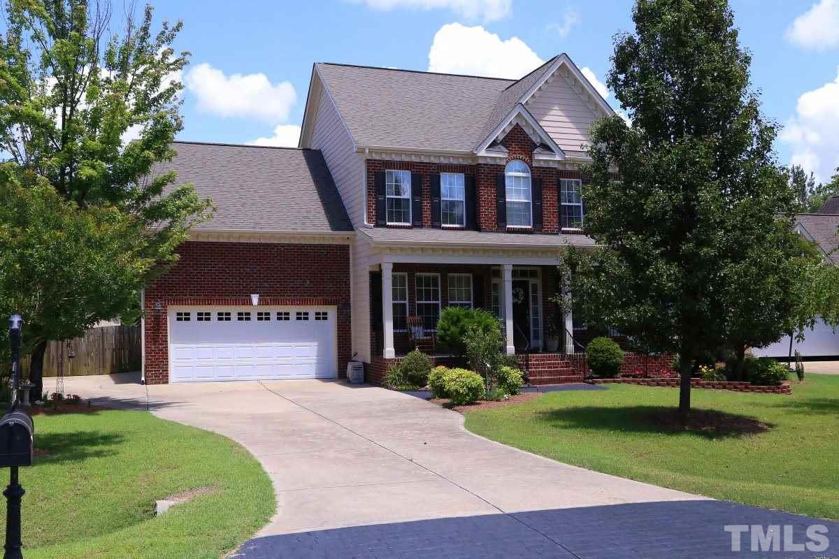 1012 Newburgh Circle Raleigh, NC 27603 - Photo 1 of 25 a front view of a house with a yard and trees