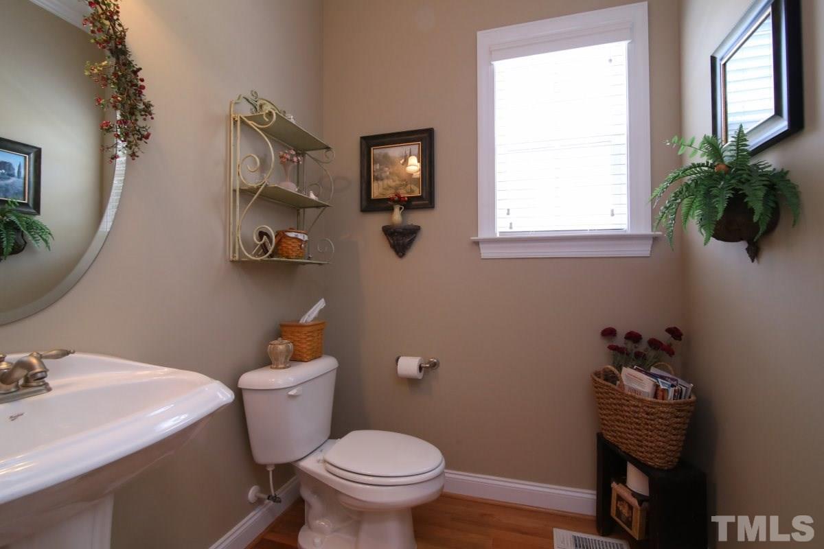 1012 Newburgh Circle Raleigh, NC 27603 - Photo 12 of 25 a bathroom with a toilet sink and mirror