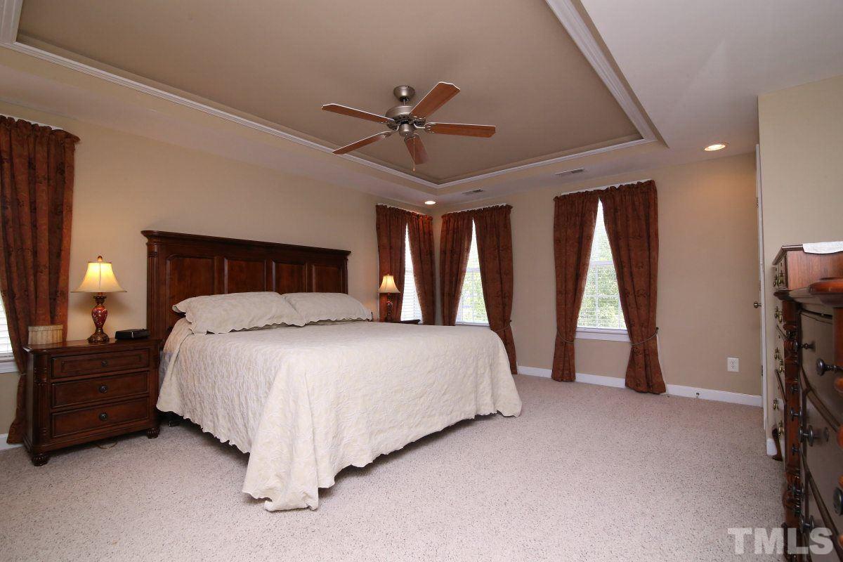 1012 Newburgh Circle Raleigh, NC 27603 - Photo 13 of 25 a bedroom with a bed and a lamp