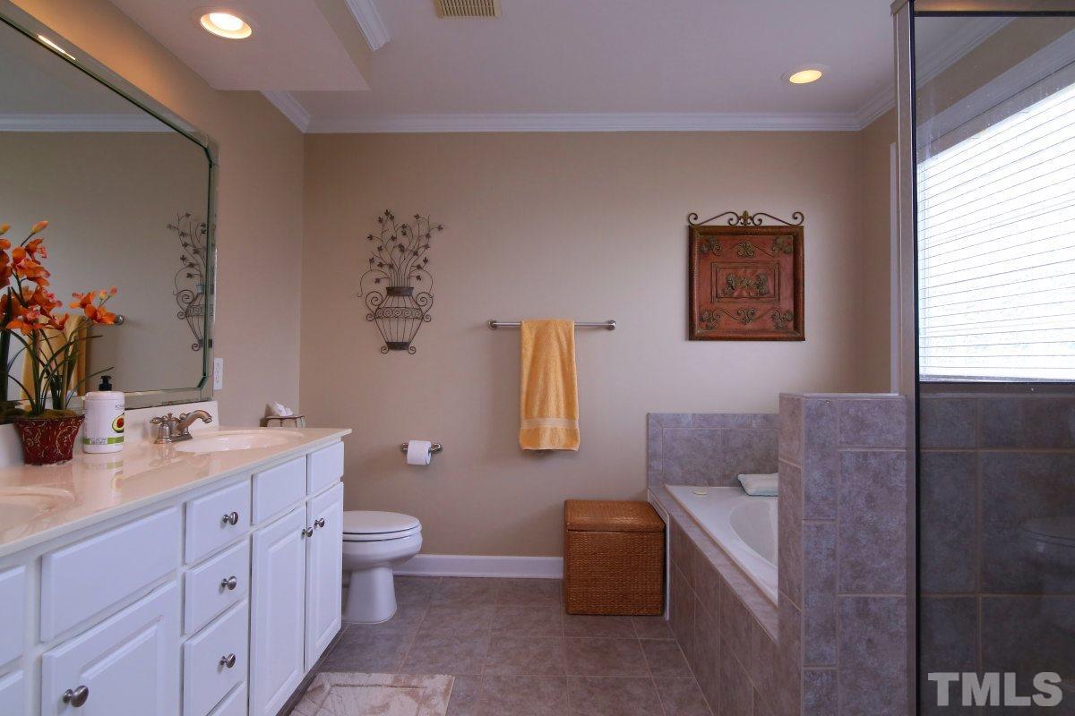 1012 Newburgh Circle Raleigh, NC 27603 - Photo 14 of 25 a spacious bathroom with a toilet sink and mirror