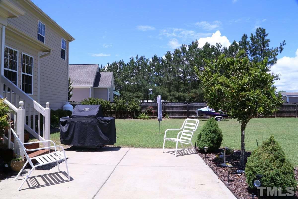 1012 Newburgh Circle Raleigh, NC 27603 - Photo 22 of 25 a view of a patio with table and chairs and potted plants