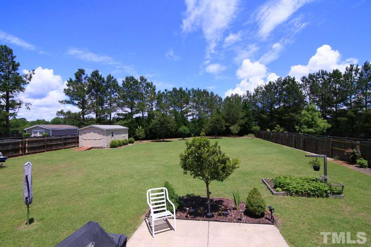 1012 Newburgh Circle Raleigh, NC 27603 - Photo 23 of 25 a view of a garden with a bench in the garden