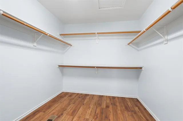 a view of a room with wooden floor