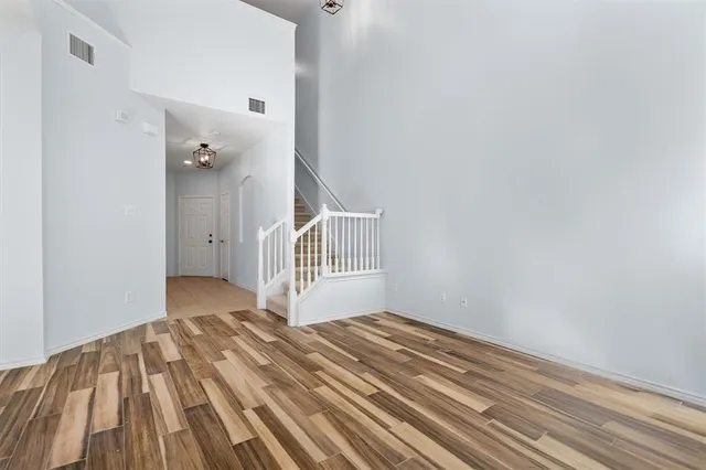 a view of a bedroom with wooden floor and a sink
