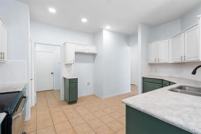 a kitchen with a stove refrigerator and cabinets