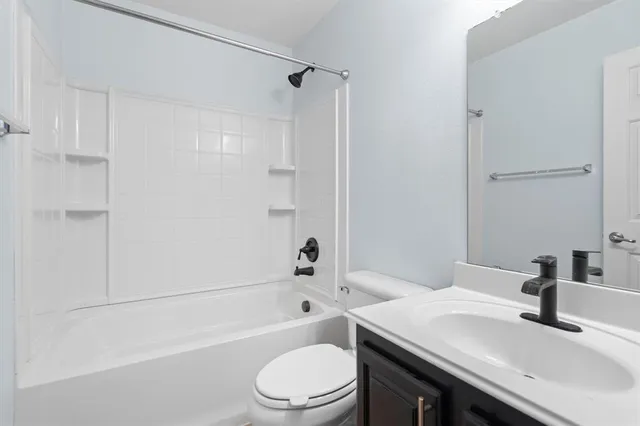 a bathroom with a sink a toilet and a bathtub