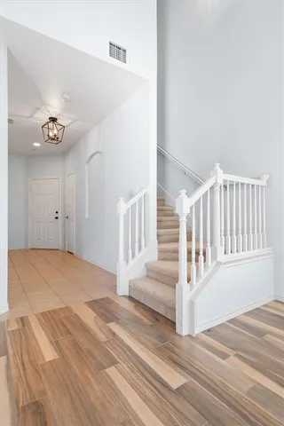 a view of a livingroom with wooden floor and white walls