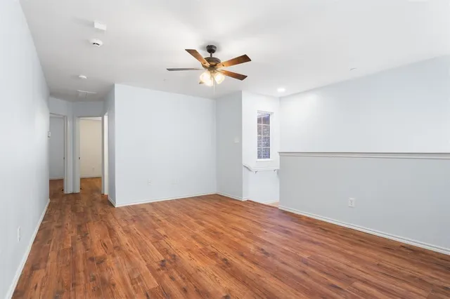 a view of a big room with wooden floor and windows in a room