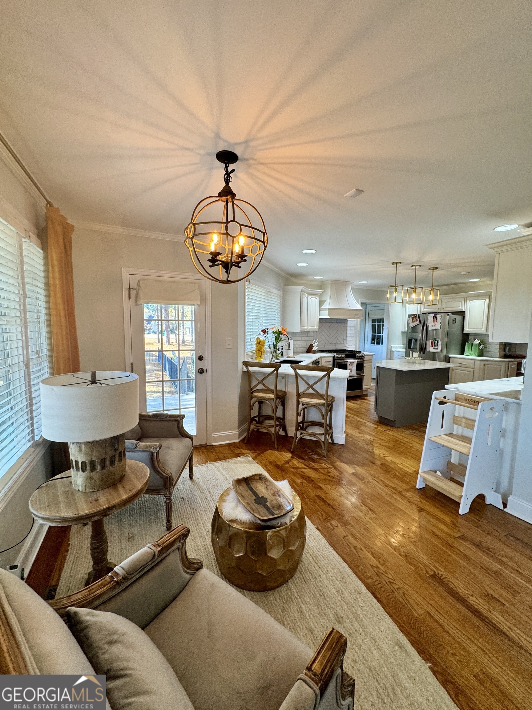 49 Aberdeen Circle Cordele, GA 31015 - Photo 16 of 63 a living room with furniture kitchen and a chandelier