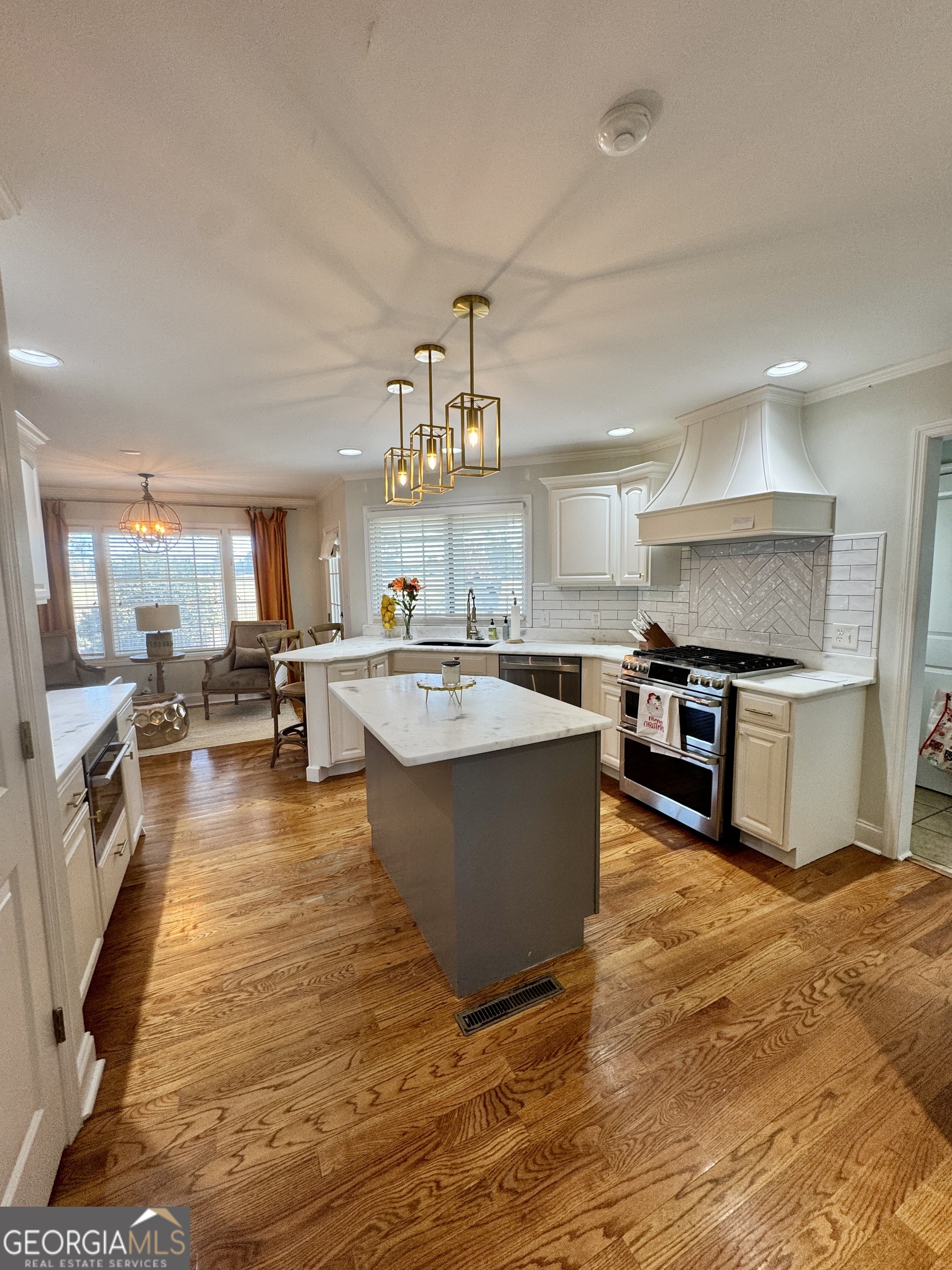 49 Aberdeen Circle Cordele, GA 31015 - Photo 20 of 63 a large kitchen with kitchen island a sink a counter top stainless steel appliances and cabinets