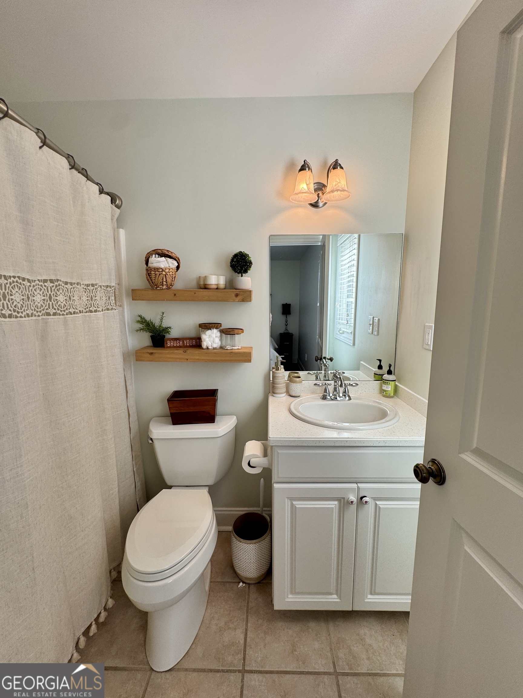 49 Aberdeen Circle Cordele, GA 31015 - Photo 40 of 63 a bathroom with a sink a toilet and a mirror