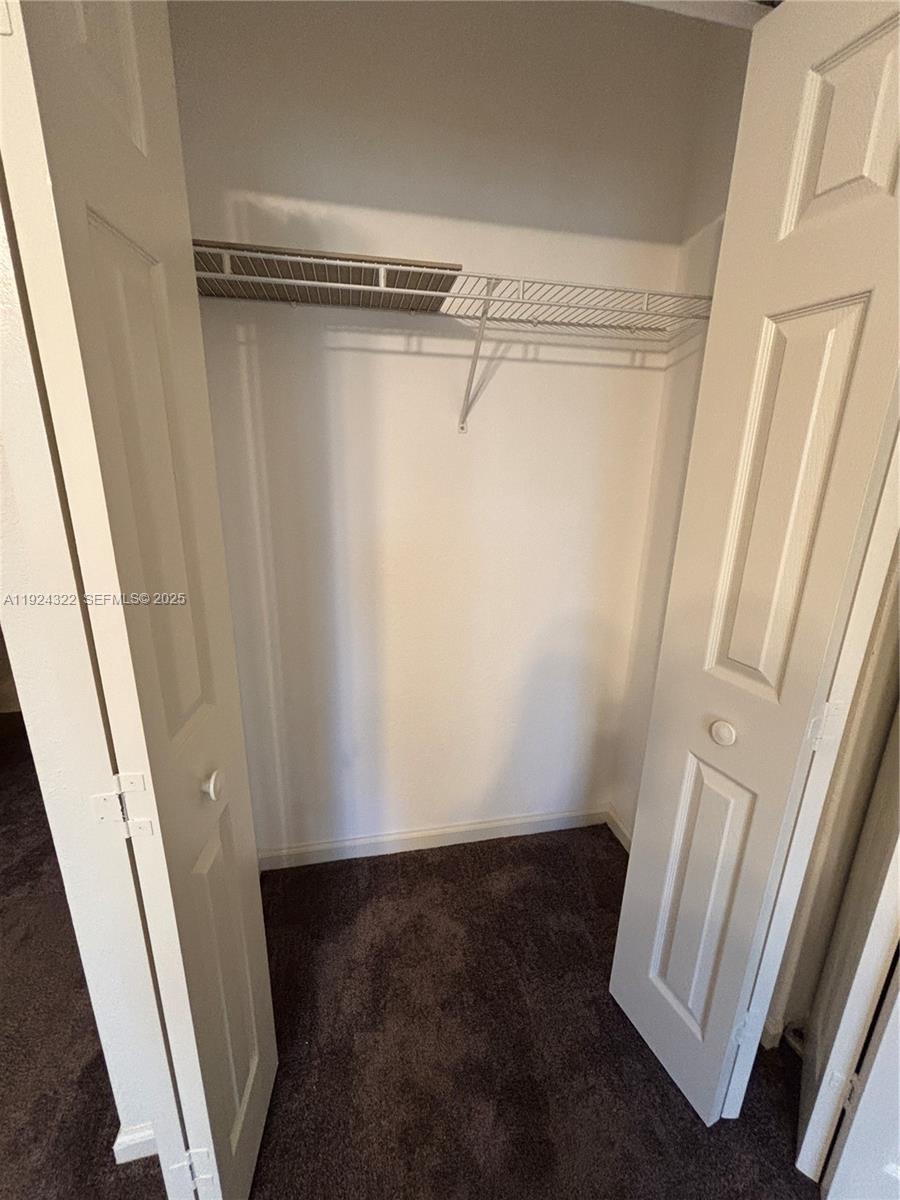 6533 Catalina Lane, Unit 6533 Tamarac, FL 33321 - Photo 15 of 27 a view of walk in closet with empty racks