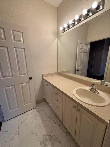 a spacious bathroom with a double vanity sink a mirror and a shower