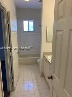 a bathroom with a tub shower and sink