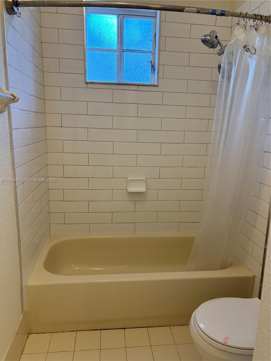 6533 Catalina Lane, Unit 6533 Tamarac, FL 33321 - Photo 23 of 27 a bathroom with a bathtub and toilet