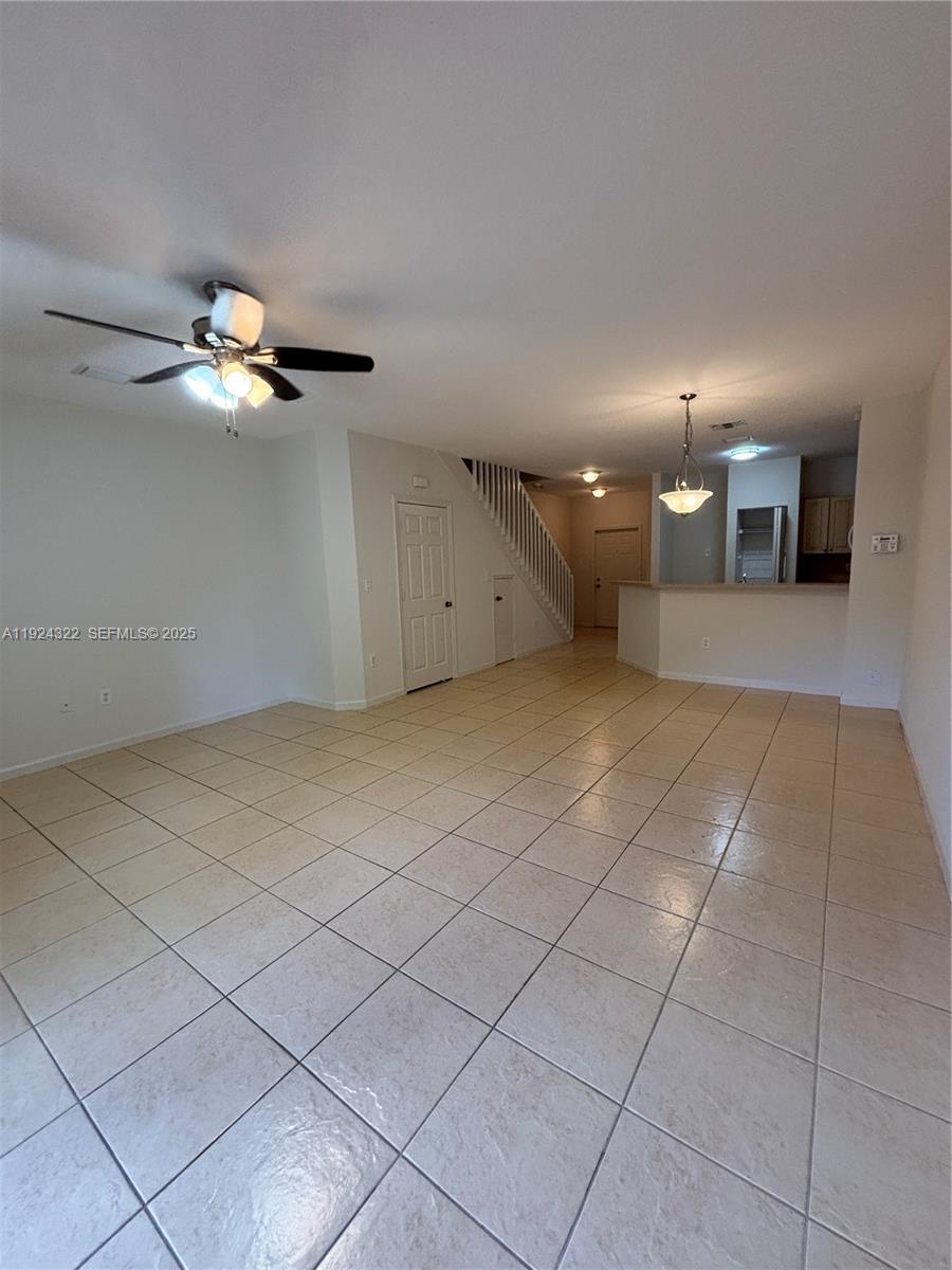 6533 Catalina Lane, Unit 6533 Tamarac, FL 33321 - Photo 3 of 27 a view of an empty room with a chandelier fan