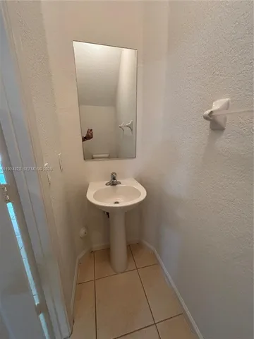 a bathroom with a sink a mirror and a toilet