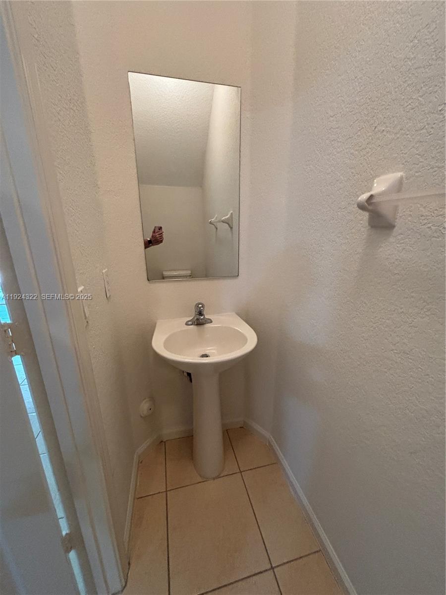 6533 Catalina Lane, Unit 6533 Tamarac, FL 33321 - Photo 8 of 27 a bathroom with a sink a mirror and a toilet