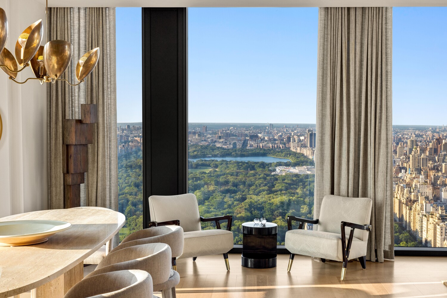 53 West 53rd Street, Unit 54A Manhattan, NY 10019 - Photo 2 of 14 a living room with furniture and a floor to ceiling window