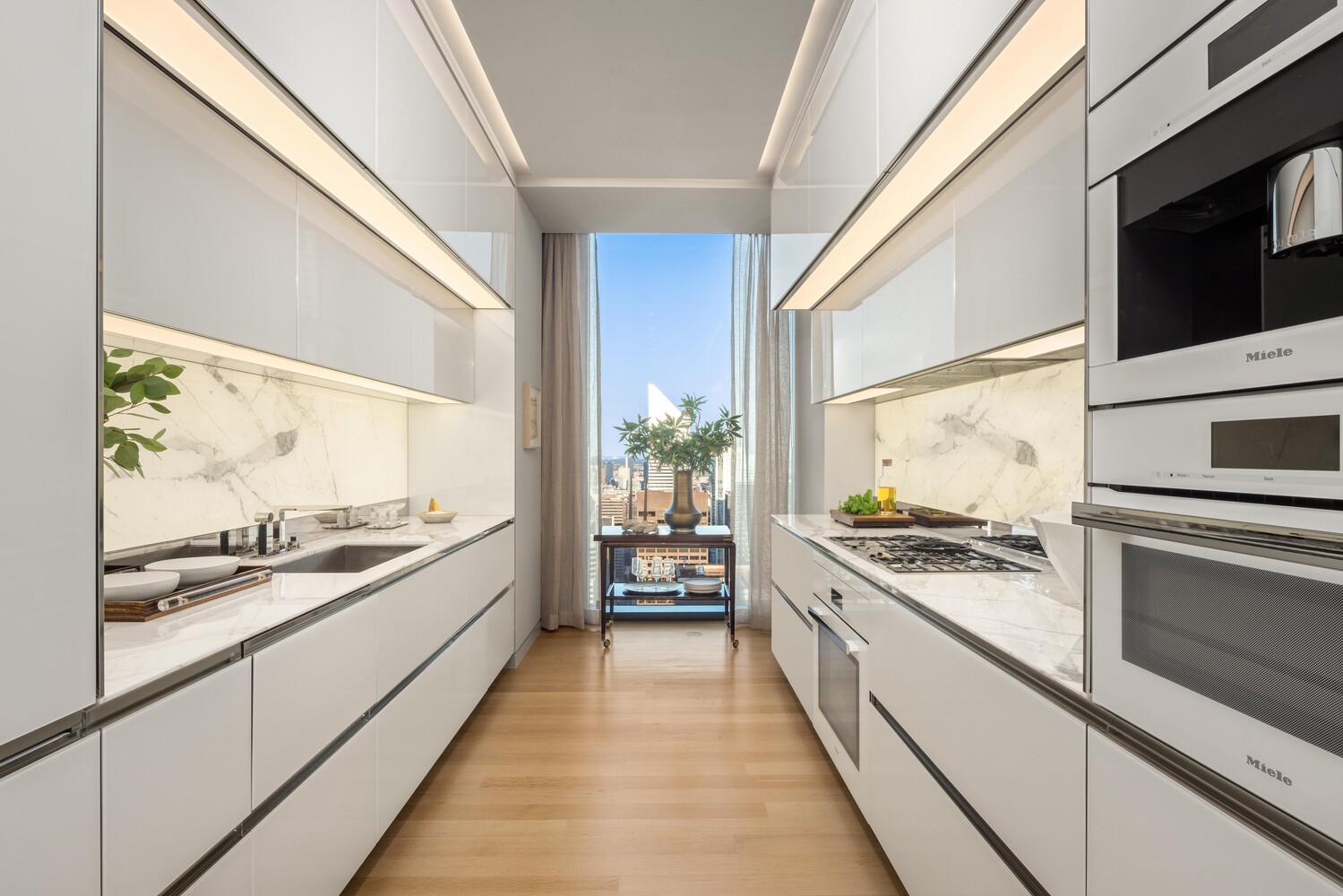 53 West 53rd Street, Unit 54A Manhattan, NY 10019 - Photo 5 of 14 a large white kitchen with a stove and a microwave