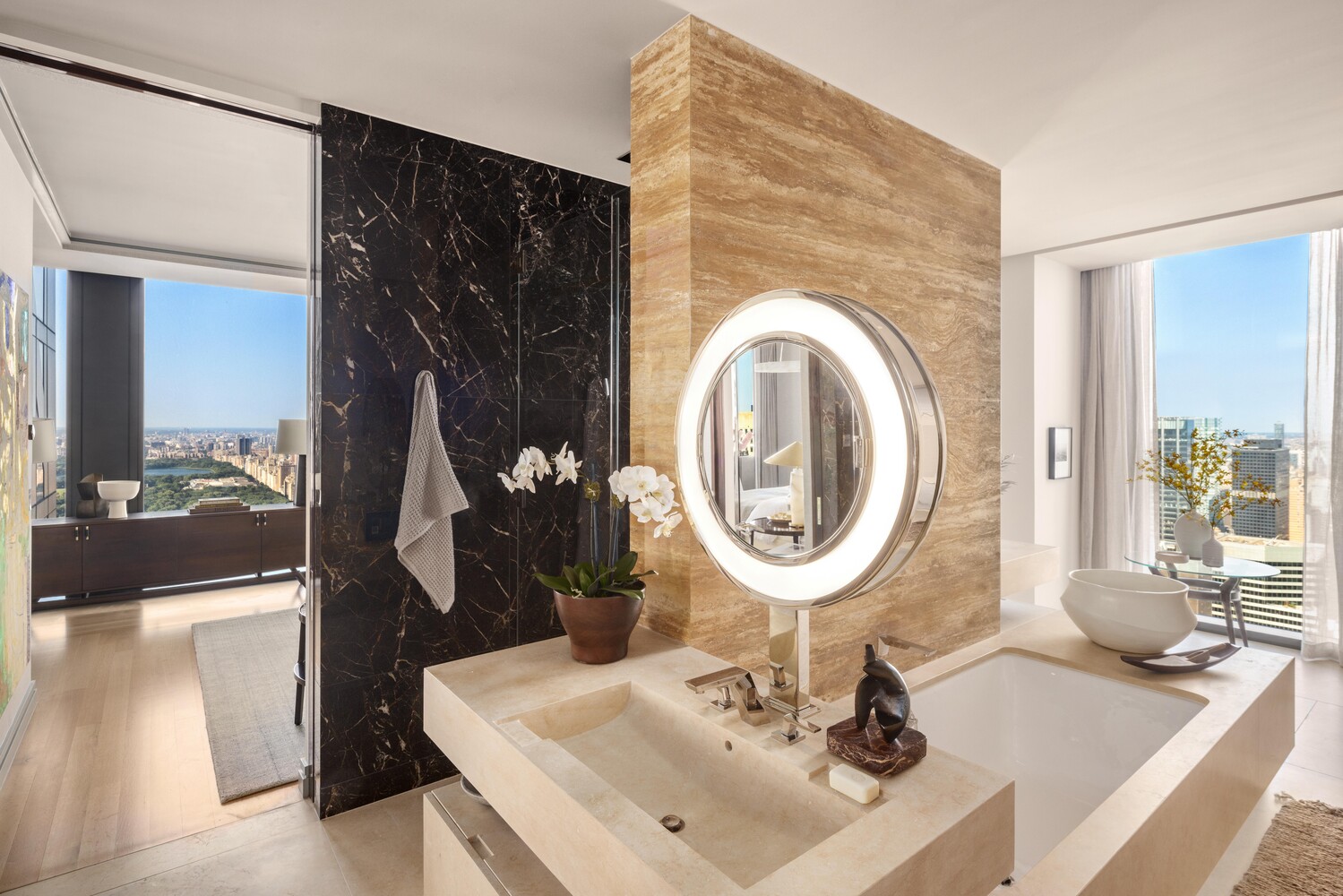 53 West 53rd Street, Unit 54A Manhattan, NY 10019 - Photo 8 of 14 a bathroom with a sink a mirror and a shower