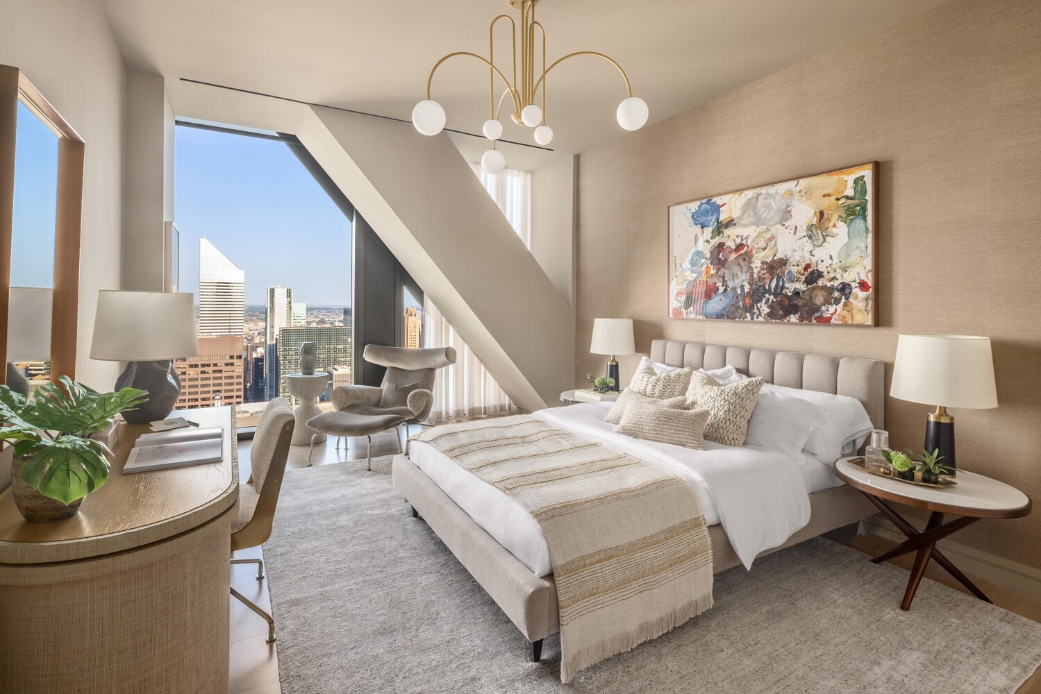 53 West 53rd Street, Unit 54A Manhattan, NY 10019 - Photo 9 of 14 a spacious bedroom with bed and a chandelier
