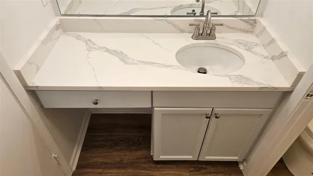 a bathroom with a sink and mirror