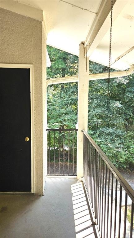 1150 Collier Road Northwest, Unit K12 Atlanta, GA 30318 - Photo 6 of 32 a view of a balcony with floor to ceiling window wooden floor and fence