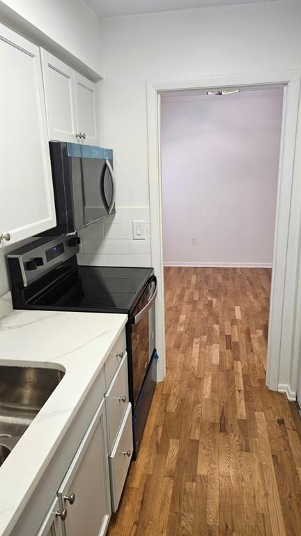 1150 Collier Road Northwest, Unit K12 Atlanta, GA 30318 - Photo 8 of 32 a view of a utility room with wooden floor
